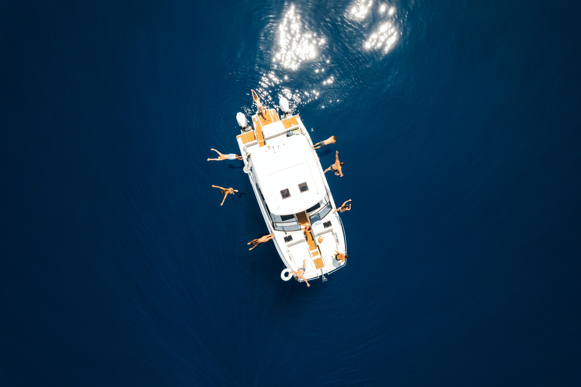 Aquila 36 from above with guests swimming