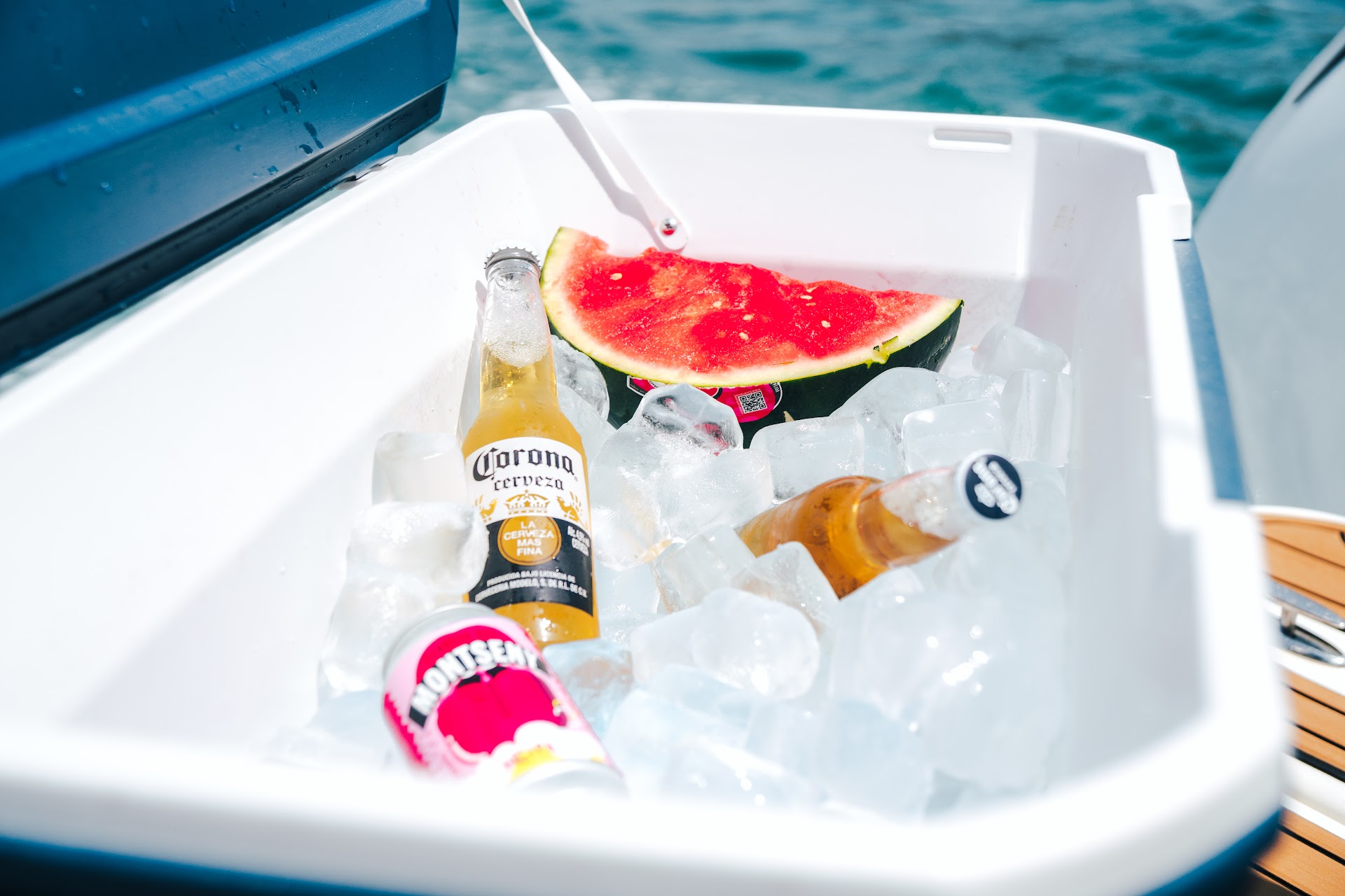 Cooler with cold drinks and watermelon